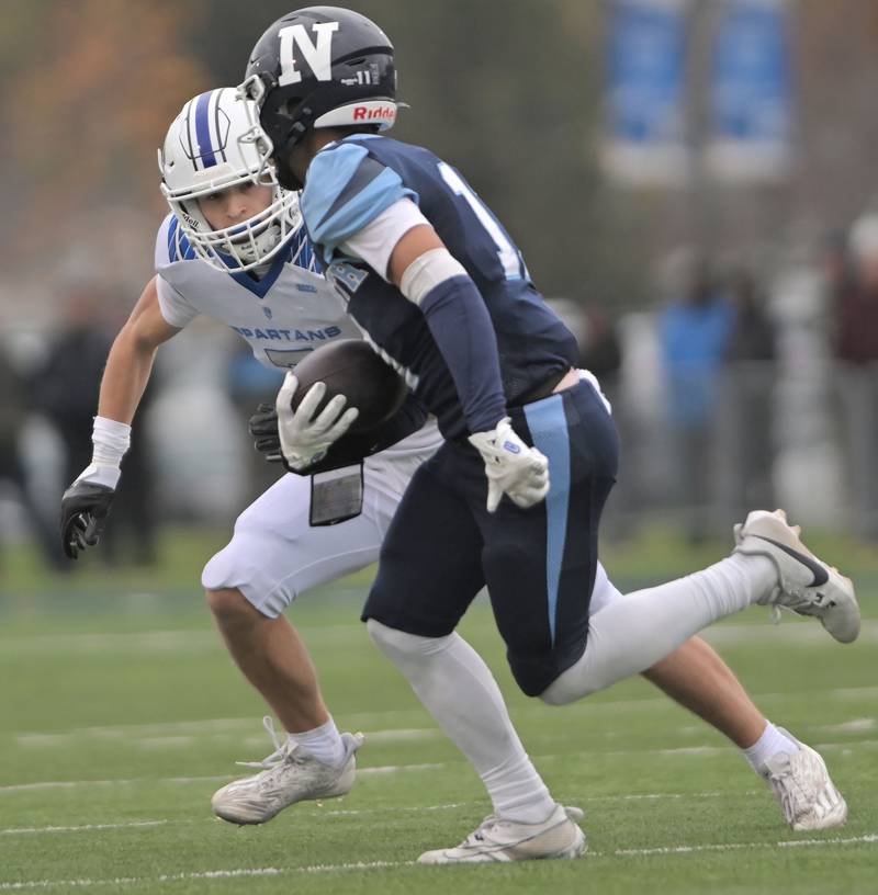 St. Francis’ Seth Valeri tracks down Nazareth’s James Penley in the IHSA Class 5A state semifinal football game in La Grange on Saturday, Nov. 23, 2024.