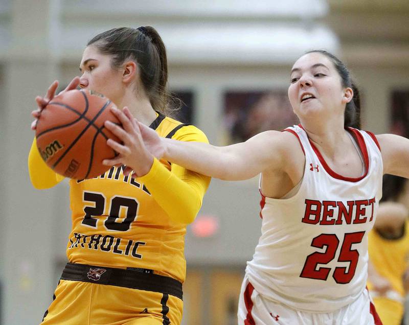 Benet’s Samantha Trimberger (25) reaches for a rebound as Carmel's Mia Gillis (20) looks for an outlet Friday November 25, 2022 in Lisle.