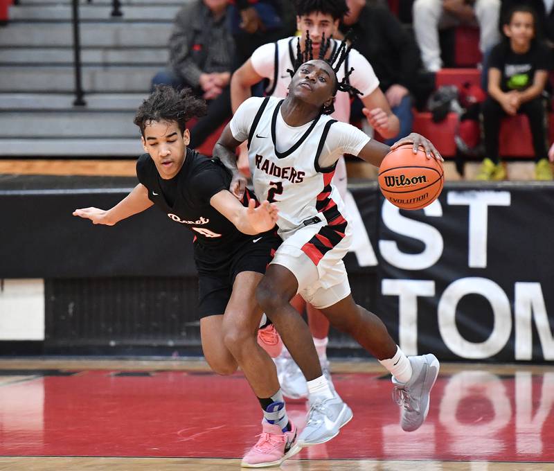 Benet's Blake Fagbemi and Bolingbrook's DJ Strong collide during a Class 4A East Aurora Sectional semifinal game on Feb. 27, 2024 at East Aurora High School in Aurora.