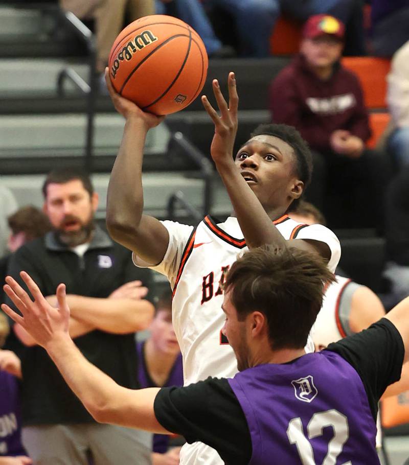 DeKalb’s Marquise Boldenshoots over Dixon’s Mason Weigle during their game Tuesday, Dec. 12, 2023, at DeKalb High School.