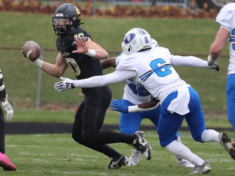 Sycamore's Burke Gautcher tries to escape the pass rush of St. Francis' Jeremy Cox Saturday, Nov. 16, 2024, during their Class 5A quarterfinal game at Sycamore High School.