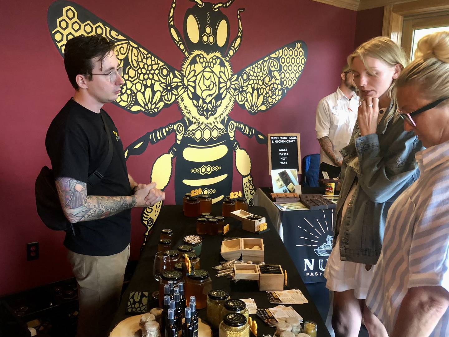 Andrew Migas of Friendly Hives showcases locally sourced honey inside Foxes Den Meadery during the Sips and Sunshine Makers Market event on June 1, 2024, in downtown Yorkville.