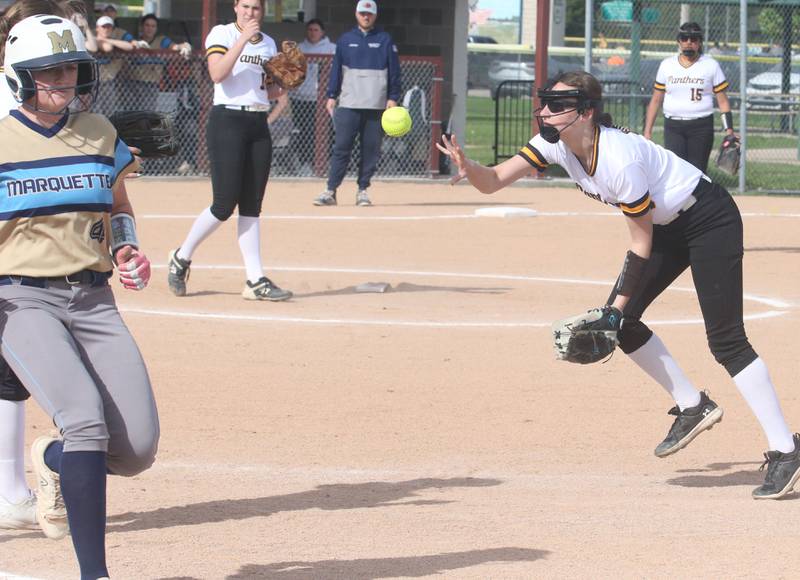 Putnam County's Sofia Borri, throws late to first base as Marquette's Hunter Hopkins runs through the bag on Tuesday, April 29, 2025 in Ottawa.