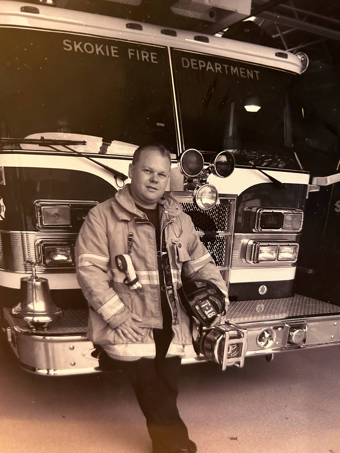 Firefighter Andy Cutting in front of the truck he drove at Station 18 in Skokie.