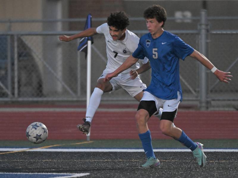 West Chicago’s Leonardo Posada takes a shot as St. Charles North’s Cameron Bettini defends him in a boys soccer game in St. Charles on Wednesday, Sept. 4, 2024.