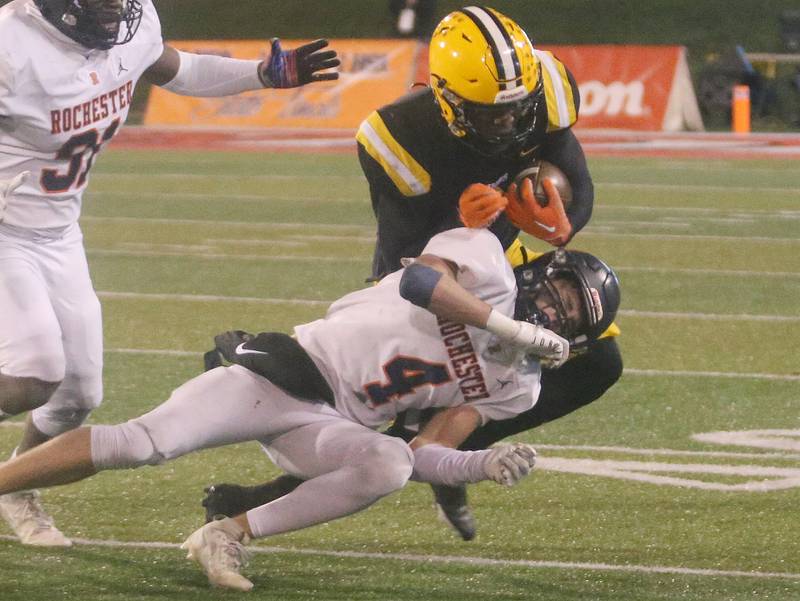 St. Laurence's Aaron Ball runs the ball as Rochester's Henry Buecker blocks him from gaining yards during the Class 4A State football championship on Friday, Nov, 24, 2023 at Hancock Stadium in Normal.