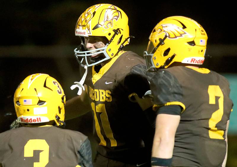 Jacobs’ Carson Goehring, center, is all smiles after a touchdown reception to close out the first half against Huntley in varsity football at Jacobs High School in Algonquin on Friday, Sept. 26, 2025.
