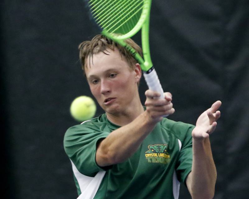 Crystal Lake South’s Jackson Schuetzle returns the ball during his IHSA 1A boys single tennis match against Alton Marguette’s  Stetson Isringhausen Thursday, May 26, 2022, at Heritage Tennis Club in Arlington Heights.