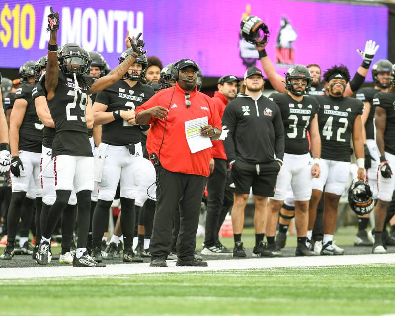 NIU’s head coach Thomas watches as some sideline players react to a field goal was good to tie the game 10-10 during the second quarter on Saturday Oct. 21, 2023, while taking on Eastern Michigan at Huskie Stadium in DeKalb.