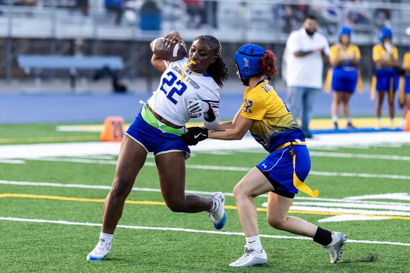 Joliet Central's Alexis Pedrosa tackles Bloom’s Karson Giles during a varsity flag football game at Joliet Central on Sept. 11, 2025.