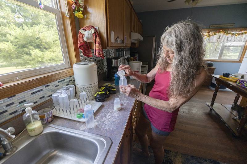 Jane Hochstatter mixes up a special formula Thursday,  June 26, 2025. The food is specific to the needs of the raccoon.