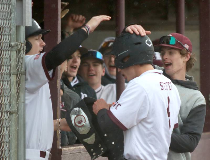 Prairie Ridge’s Karson Stiefer is greeted after coming around to score against Jacobs in varsity baseball on Wednesday, April 9, 2025, at Prairie Ridge High School in Crystal Lake.