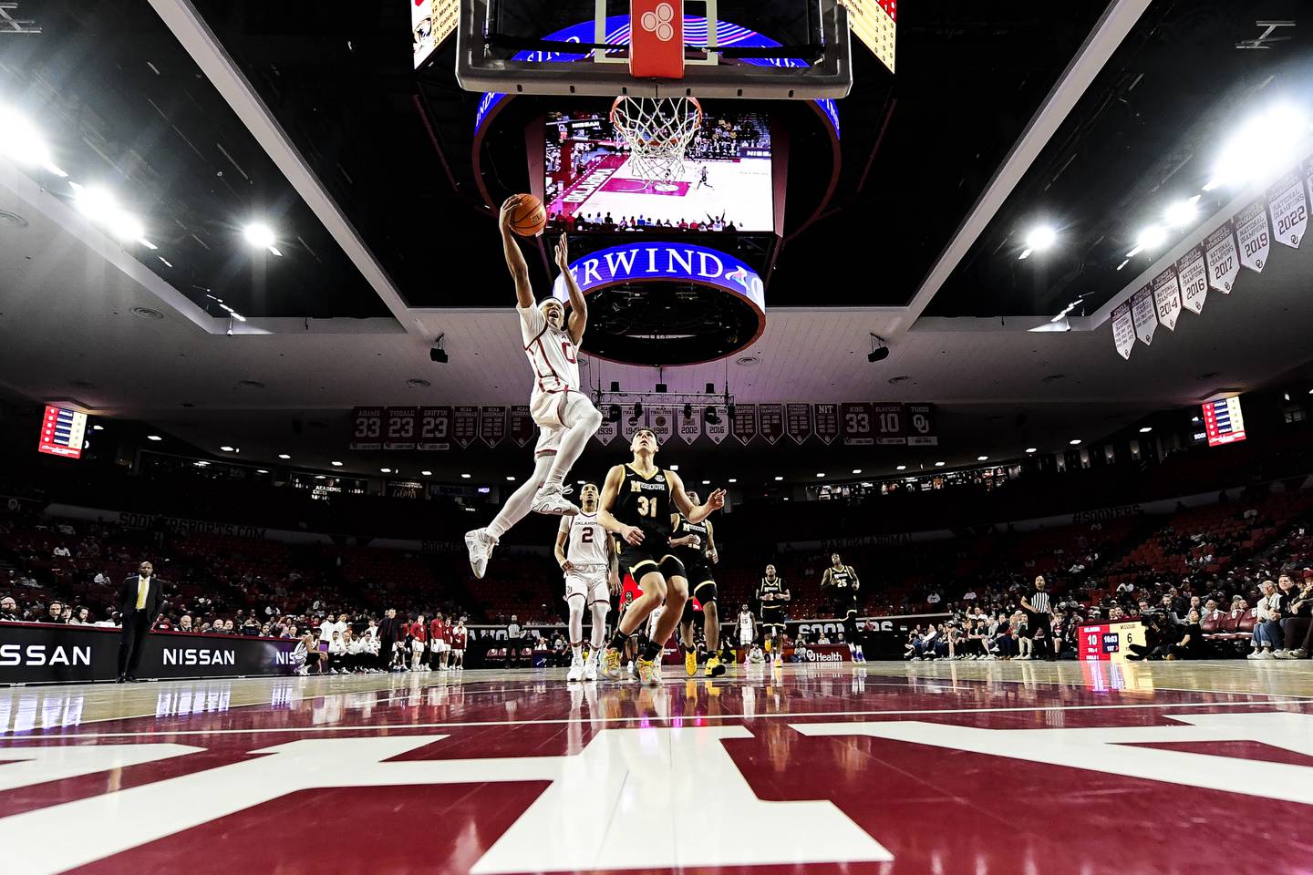 Oklahoma guard Jeremiah Fears (0) shoots past Missouri guard Caleb Grill (31) during the first half of an NCAA college basketball game, Wednesday, March. 5, 2025, in Norman, Okla. (AP Photo/Gerald Leong)