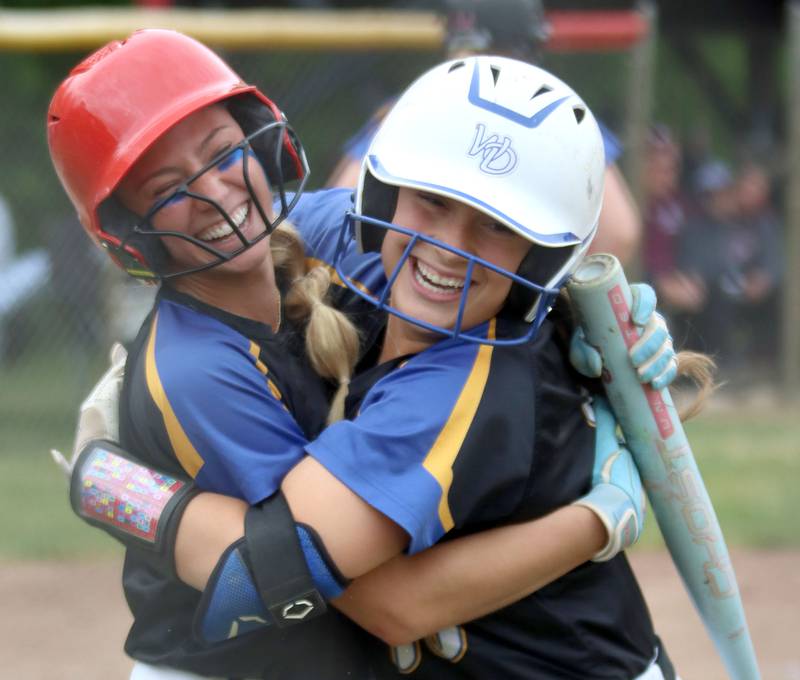 Aurora Central Catholic’s Grace Grunloh, left, celebrates arriving safely at home to score the game winning run against Marengo in varsity girls softball IHSA Class 2A Regional Title Game action on Friday, May 22, 2026 at Raymond Benoy Field on the campus of Marian Central High School in Woodstock.