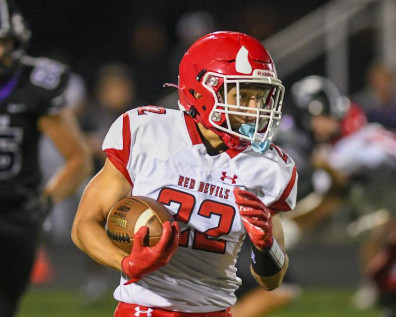 Hinsdale Central's Dominic Tresslar (22) runs the ball during the game on Friday Sept. 12, 2025, while traveling to take on Downers Grove North High School.