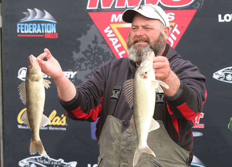 Dave Gossar of Serena, holds his fish that he caught during the annual Masters Walleye Circuit tournament on Friday, March 21, 2025 at the Spring Valley Boat Club.