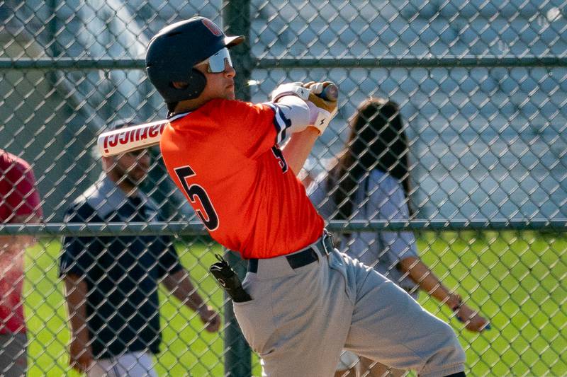 Oswego’s Ethan Valles (5) singles against Oswego East during a baseball game at Oswego East High School on Wednesday, May 10, 2023.