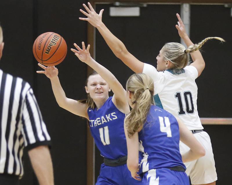 Woodstock's Abby Pagnotta passes the ball to her teammate, Lily Novelle, as she is guarded by Woodstock North’s Addison Rishling during a Kishwaukee River Conference girls basketball game on Friday, Jan. 5. 2024, at Woodstock North High School.