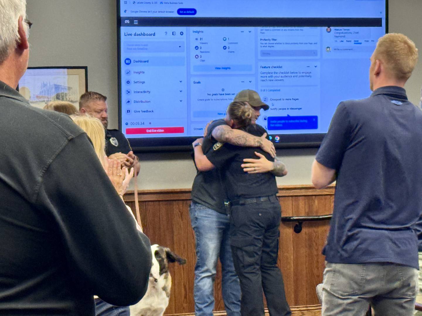 Peru Police Chief Sarah Raymond hugs Patrol Officer Damien Presthus, an active Specialist in the Army Reserves after receiving the Patriotic Employer Award. Presthus nominated Raymond for the award. Raymond received a standing ovation during Monday nights council meeting.