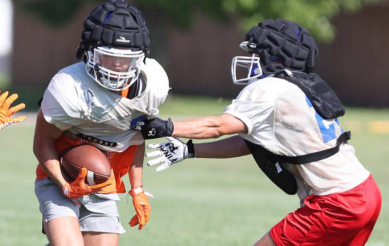 Genoa-Kingston's Brody Engel pulls away from a defender Wednesday, Aug.10, 2022, during practice at the school in Genoa.