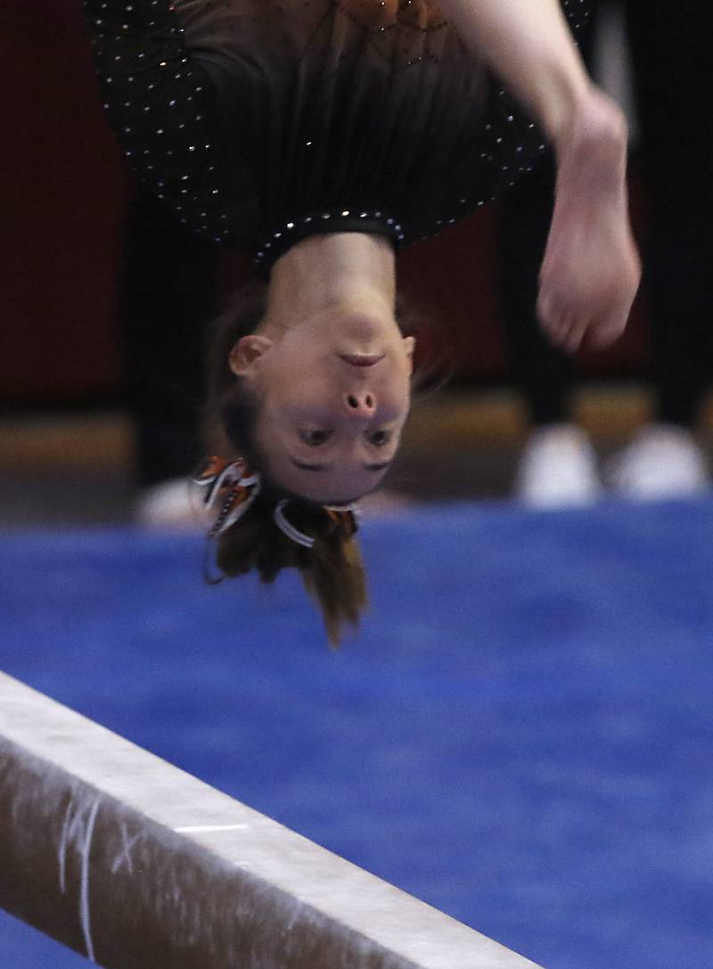 Libertyville’s Anna Baker competes in the preliminary round of the balance beam Friday, Feb. 17, 2023, during the IHSA Girls State Final Gymnastics Meet at Palatine High School.