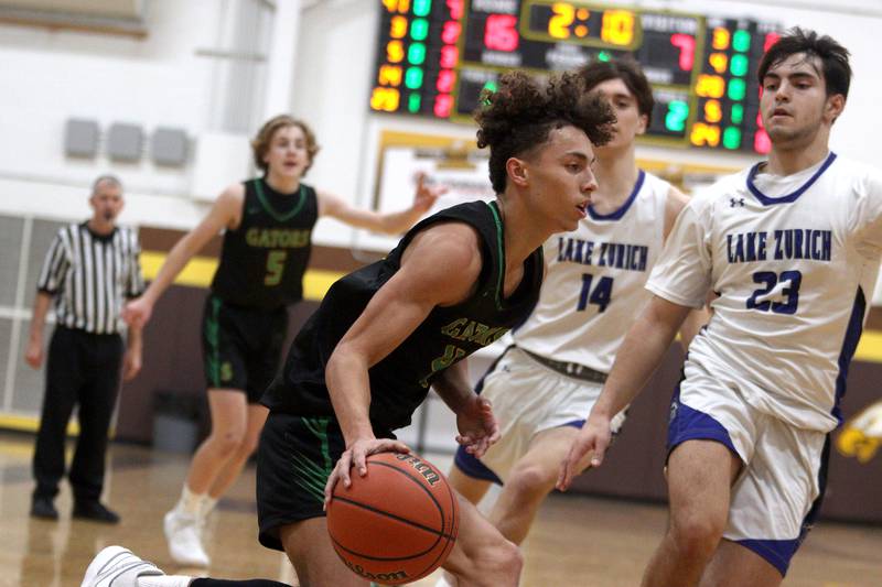 Crystal Lake South’s AJ Demirov drives against Lake Zurich in Hinkle Holiday Classic boys basketball tournament game action at Jacobs High School Wednesday.
