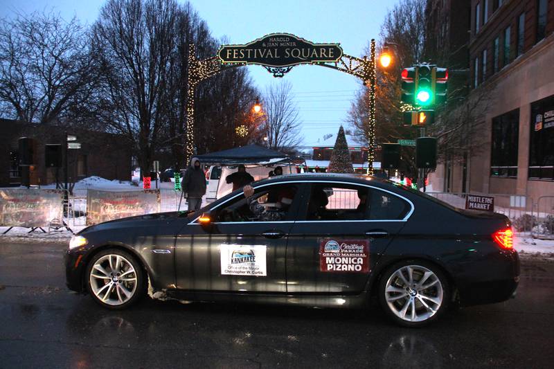 Parade grand marshal Monica Pizano leads the Kankakee Christmas Parade, driven by Kankakee Mayor Chris Curtis, on Saturday, Dec. 13, 2025.