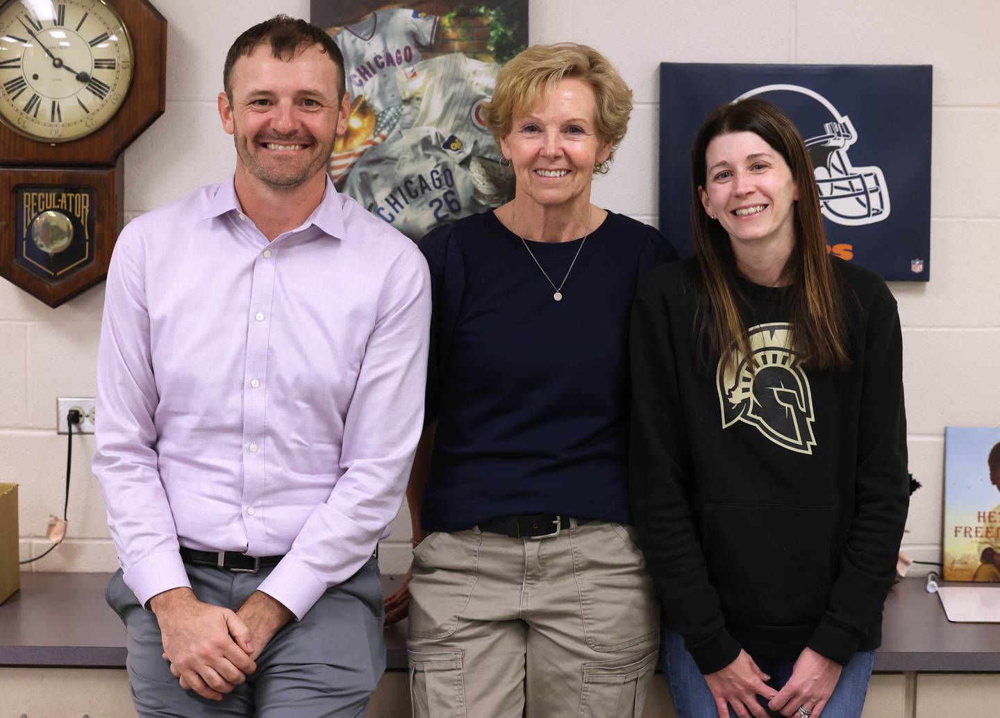 Whitney Wheeler, (right) a third grade teacher,  who all work at South Prairie Elementary School in Sycamore this year, smile Friday, April, 11, 2025, in Dan Wheeler’s classroom at the school.