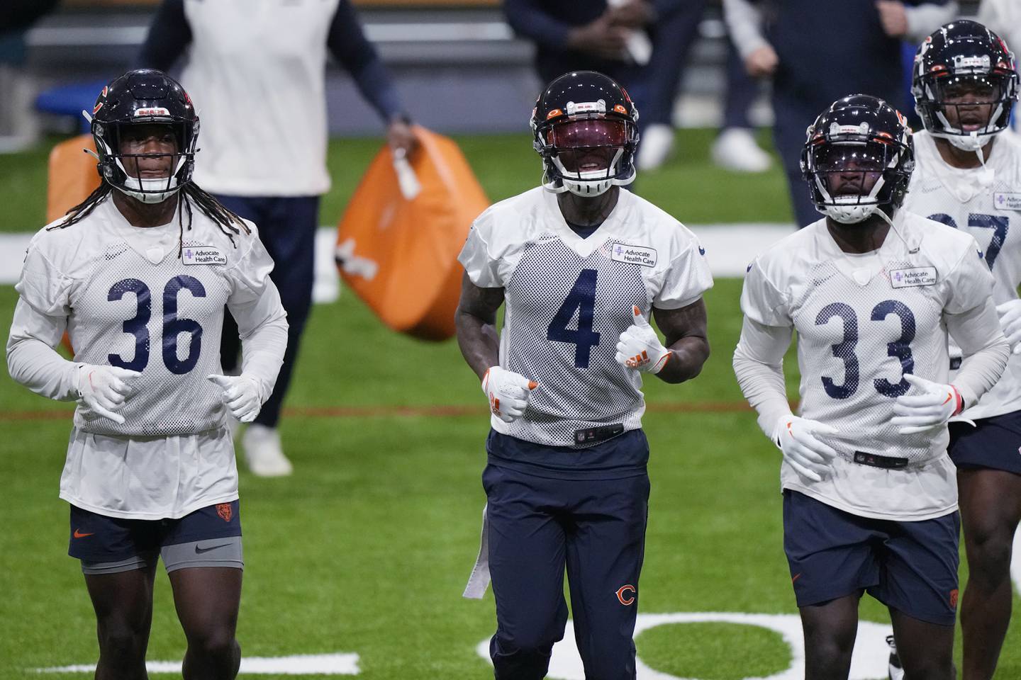 Chicago Bears defensive backs Kendall Williamson (left), Eddie Jackson and Jaylon Johnson run on the field during the team's training camp, Wednesday, July 26, 2023, in Lake Forest.