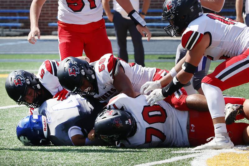 Newman Catholic's Matthew Blackert was pushed back by a trio of Panthers Braedyn Frank, Jordae Crow,  John Holland Saturday in Sterling as the Comets hosted the Panthers for week 3 of the season.