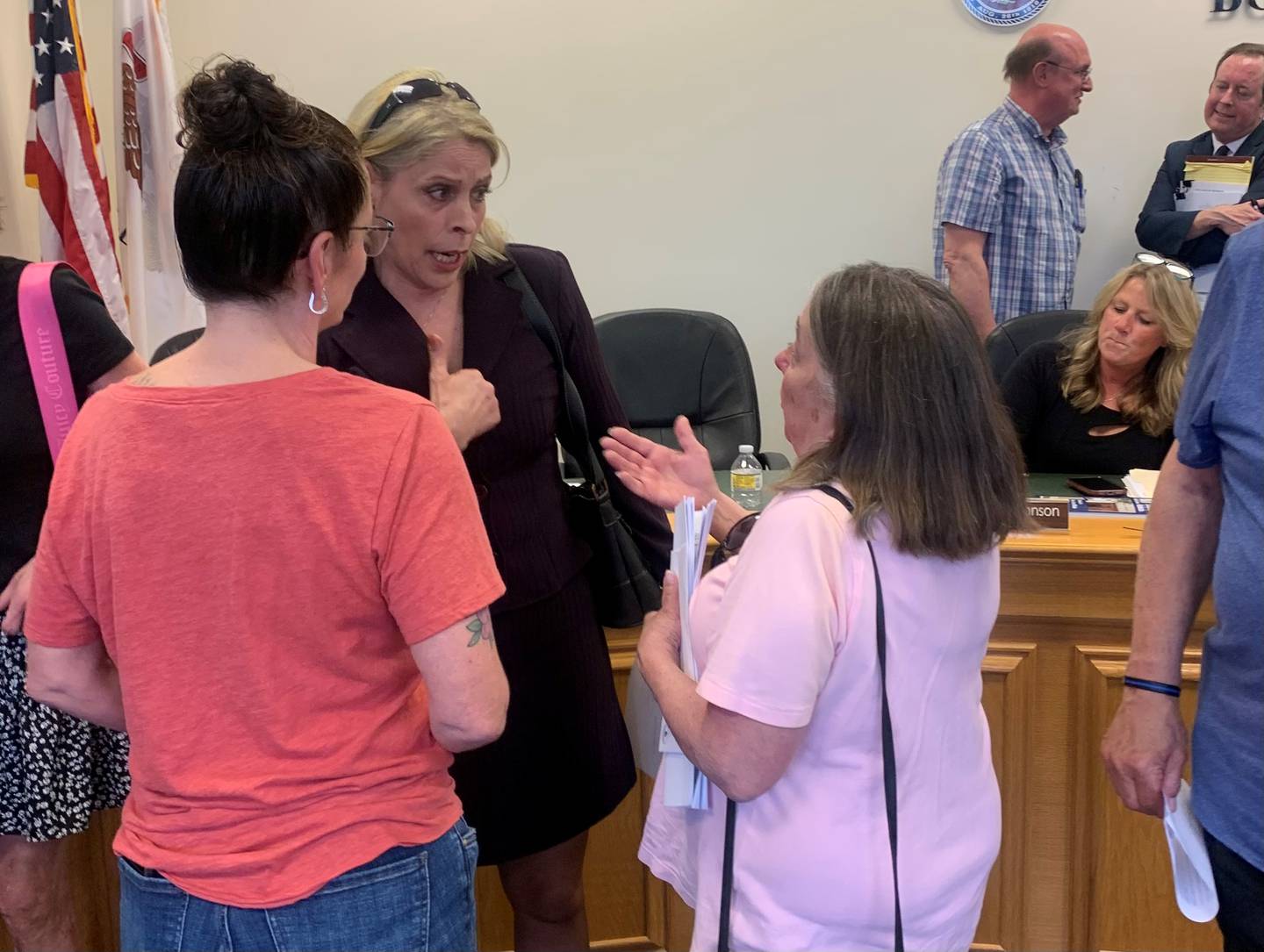 Newly reappointed Hebron Police Chief Juanita Gumble, center, who was rehired to serve in an interim capacity, chats on May 12, 2025, with Susan Fotland, right, who was reappointed village treasurer.