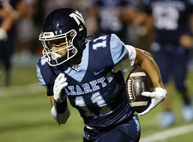 Nazareth's James Penley (11) runs during the varsity football game between Joliet Catholic and Nazareth academies on Friday, Sep. 27, 2024 in La Grange Park.