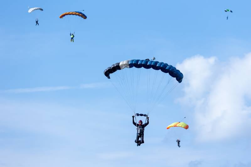 Skydivers glide towards drop zone on Friday, Aug 22, 2025 above Skydive Chicago in Ottawa.