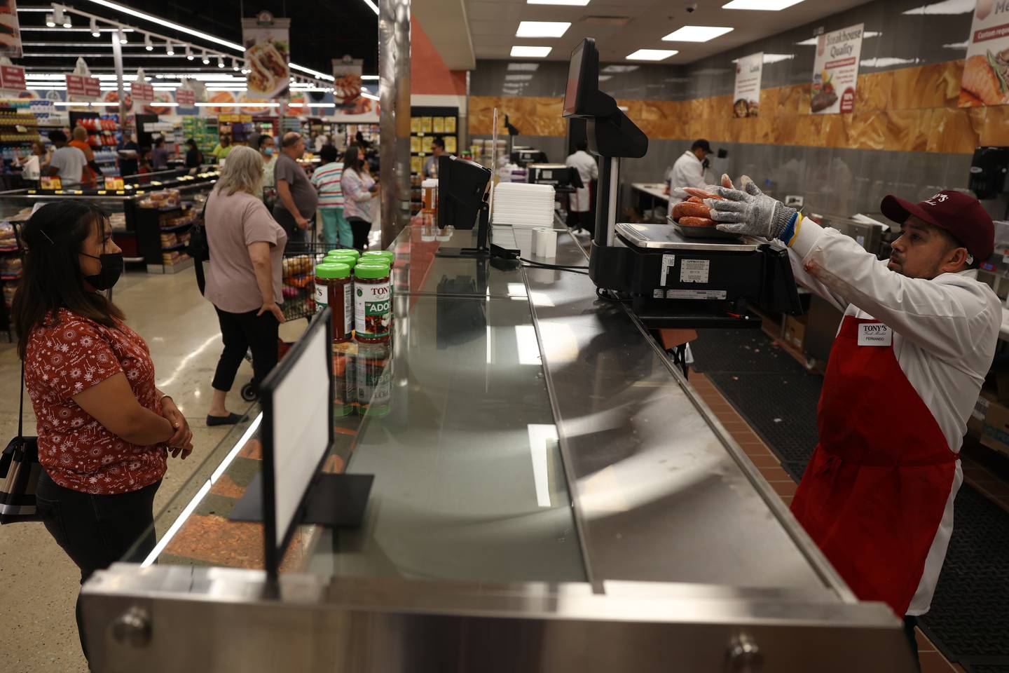 A worker weighs out some meat for a costumer at Tony’s Fresh Market grand opening in Joliet. Wednesday, June 28, 2022 in Joliet.