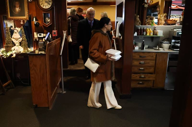 Customers get ready to leave Merichka’s the day after a shooting outside the restaurant in Joliet.