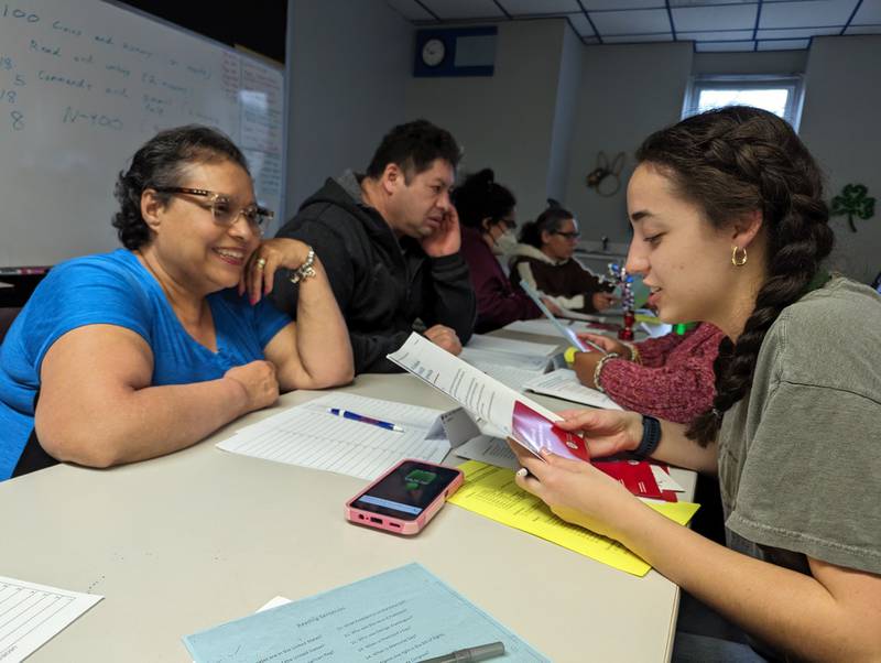 Sophia Leverett, co-president of the Spanish Honors Society at Providence Catholic High School in New Lenox, conducts a mock citizenship interview with a participant at the Spanish Community Center in Joliet.