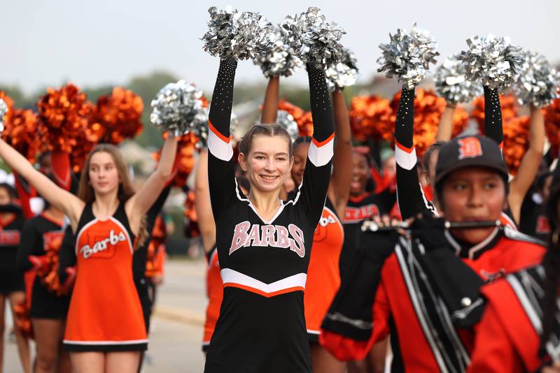 Members of the DeKalb High School dance team and cheerleaders head down Dresser Road Wednesday, Sept. 27, 2023, during the homecoming parade.