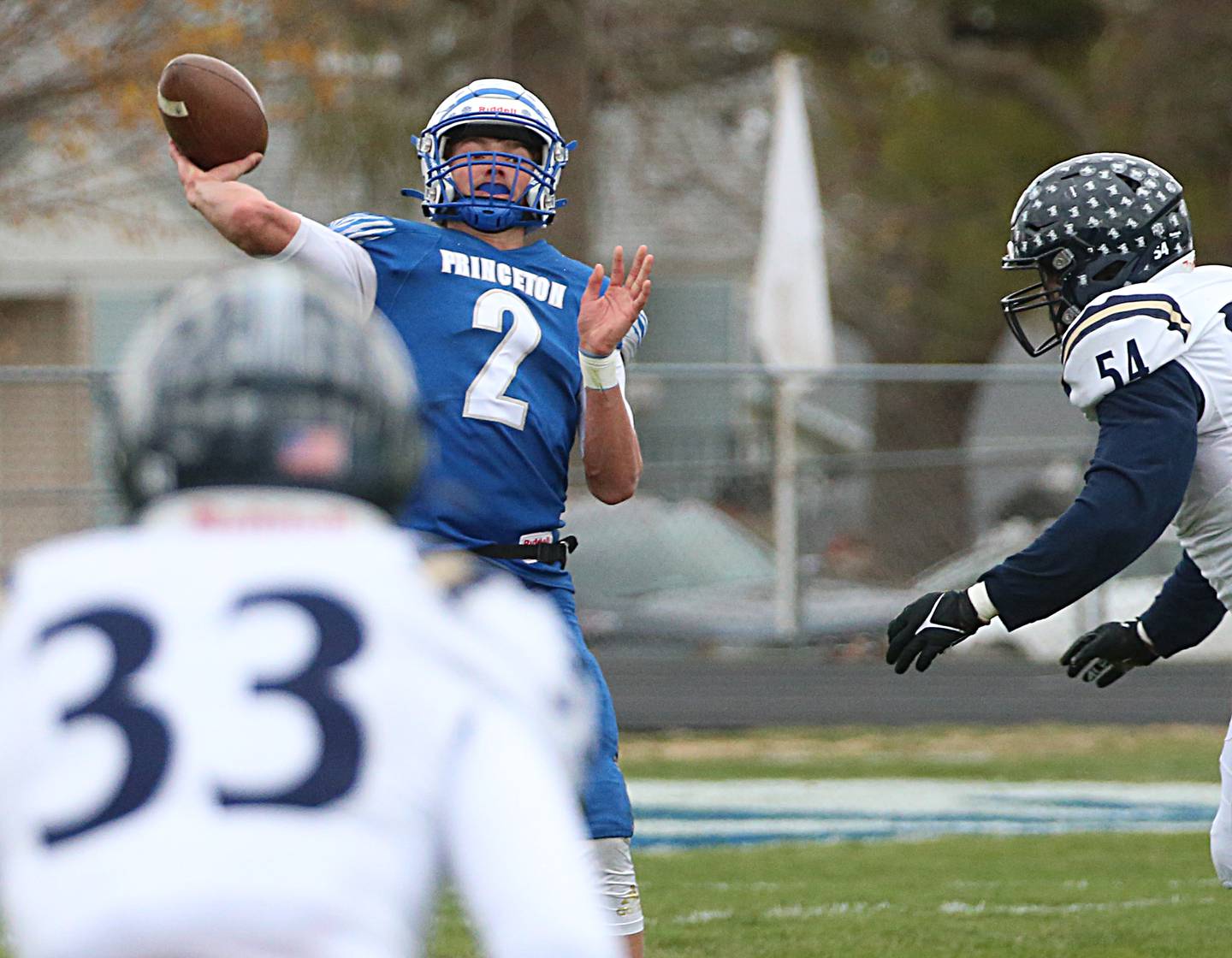 Princeton quarterback Teegan Davis throws a pass as IC Catholic's Joey Gliatta (33) and Jayden Sutton defend in the Class 3A Quarterfinal game on Saturday, Nov. 12, 2022 in Princeton.