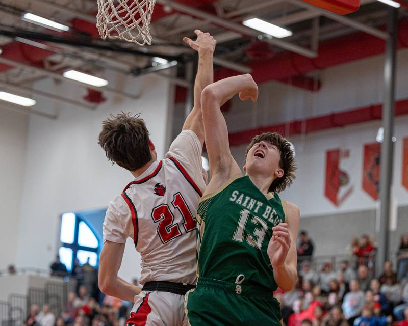 Hall's Clayton Fusinetti (21) leaps in attempt to contest shot from St. Bede's Graham Ross (13) on Saturday, January 31, 2026 at Hall High School in Spring Valley.