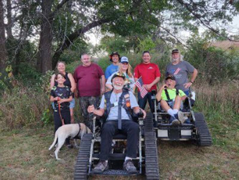 Josh Deron (in red) organizes nature hikes as part of work at Veterans Path to Hope to bring veterans and their families together to connect and heal.