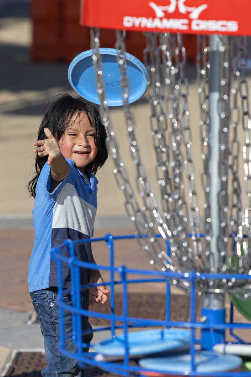 Diego Lima, 4, of Dixon, practices his disc golf skills Wednesday, July 23, 2025, at Dixon’s City Market. Heat kept the crowds at bay a bit for the weekly downtown gathering of arts, crafts, food, drink and music.