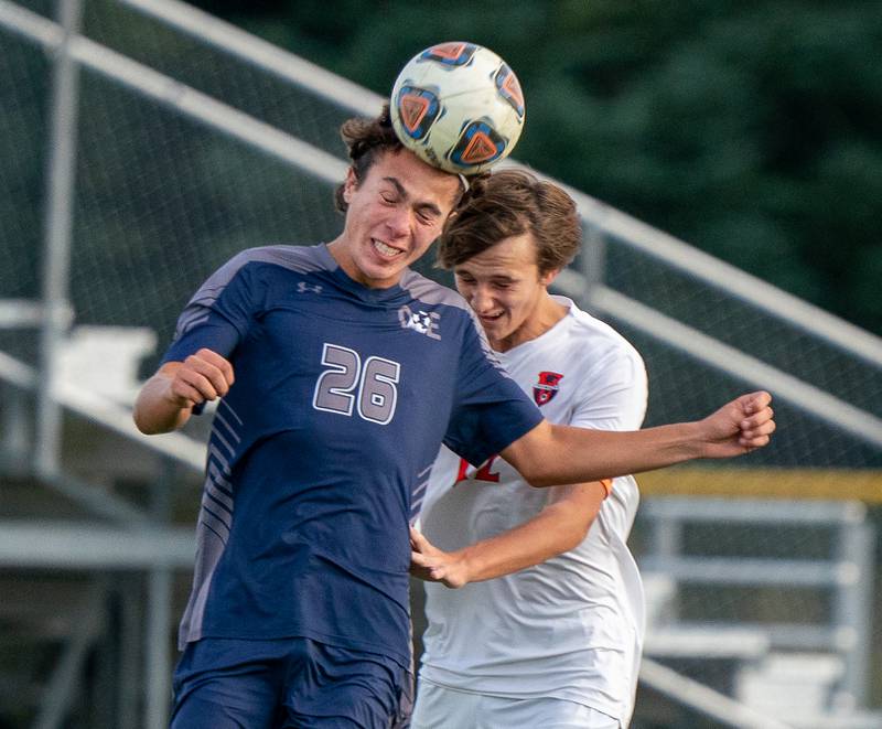 Oswego East's Josh Lopez (26) goes up for a header against Oswego’s Ryan Walsh (12) during a soccer match at Oswego East High School on Monday, Sep 26, 2022.