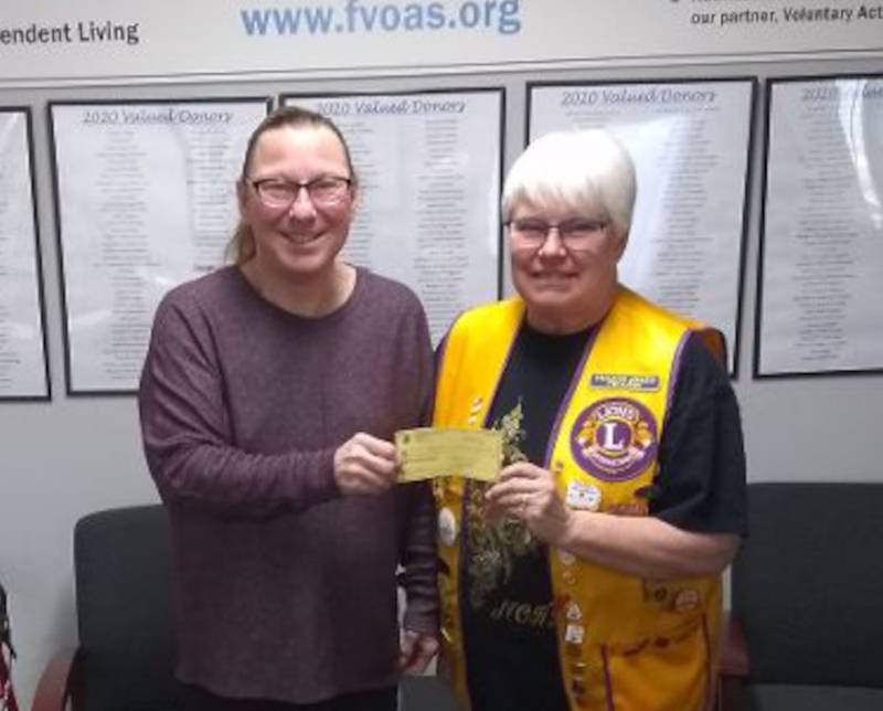 Sandwich Lions Club President Sharon Wallis, right, presents a $1,000 donation to Suzanne Kinsey, executive director of Fox Valley Community Services.