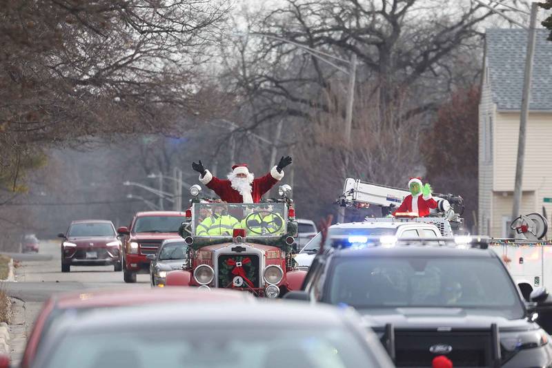 Joliet police, fire and public works vehicles escort Santa through Joliet before he heads off to the North Pole for the annual Santa Send-Off on Saturday, Dec. 14, 2024 in Joliet.