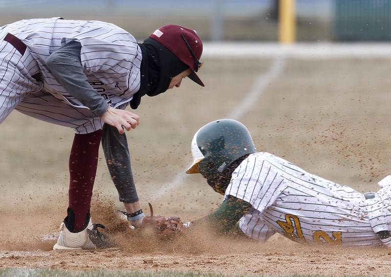 Richmond-Burton’s Johnny Larsen tries to tag Crystal Lake South’s Ryan Skwarek as Skwarek slides into third base during a nonconference baseball game Friday, March 24, 2023, at Crystal Lake South High School.