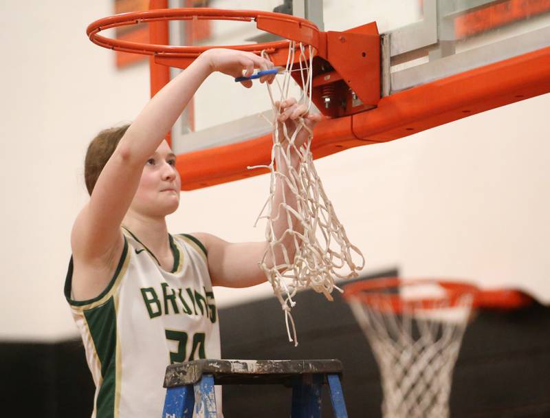St. Bede's Lili McClain cuts down a piece of the net after defeating Serena in the Class 1A Sectional final game on Thursday, Feb. 22, 2024 at Gardner-South Wilmington High School.