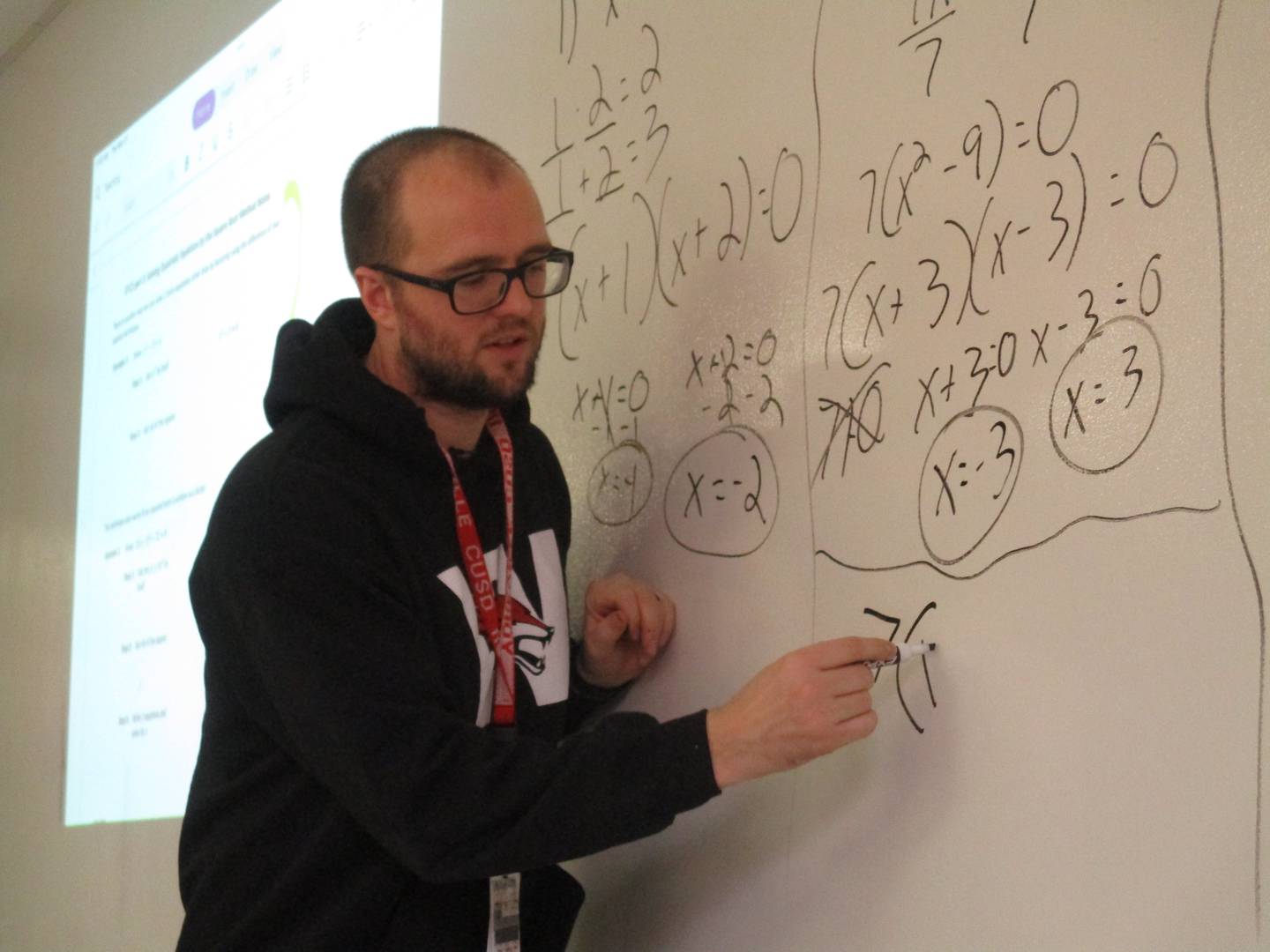 Yorkville High School mathematics teacher Scott Roseberg works out a problem for his students. (Mark Foster -- mfoster@shawmedia.com)
