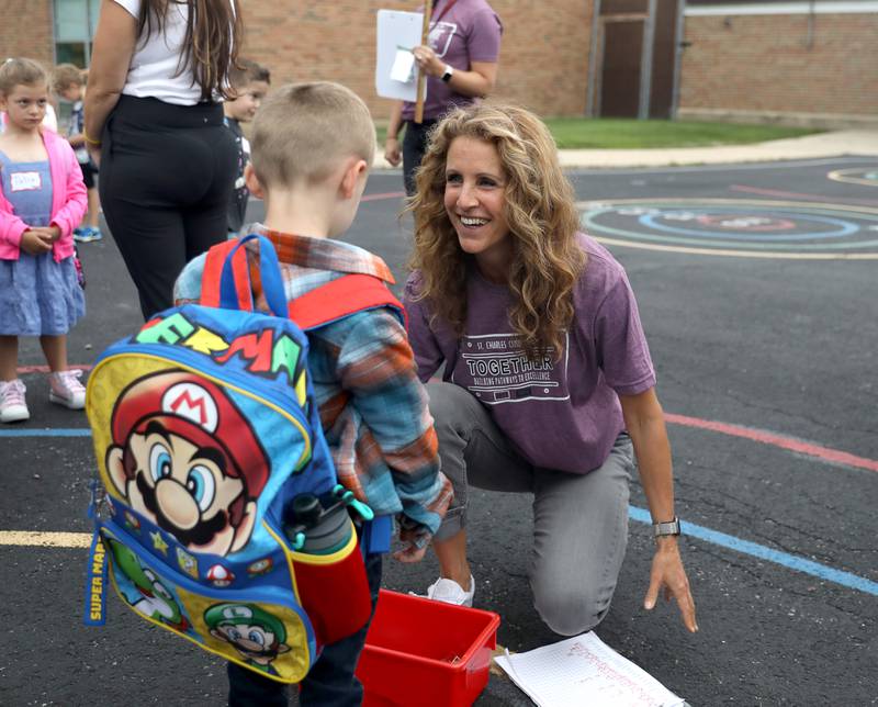 Kindergarten teacher Katherine Thompson chats with student Allen O’Brien on the first day of school at Wild Rose Elementary School in St. Charles on Monday, Aug. 14, 2023.f