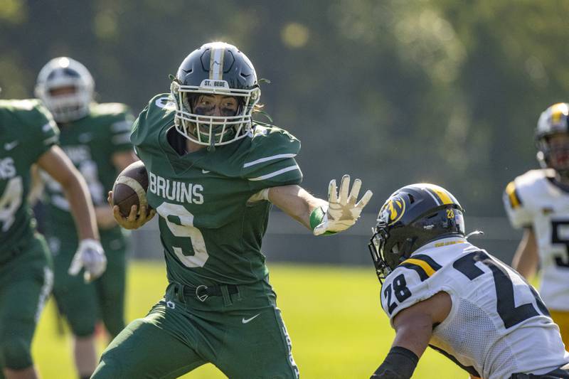 St. Bede quarterback Max Bray blocks the would be tackle from the Elmwood Park's defense and scores the touchdown that would seal the Bruins victory on September 30, 2023.