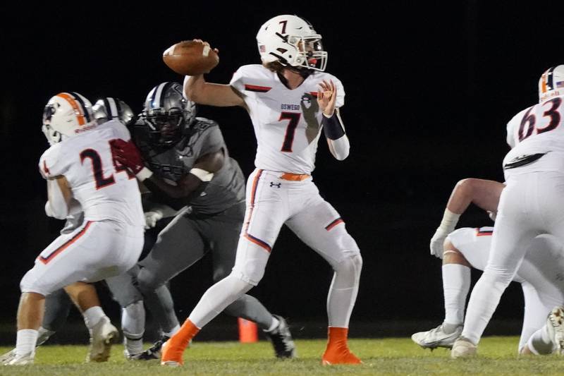 Oswego’s Brett Connolly (7) throws a pass during a football game against Oswego East at Oswego East High School on Friday, October 25, 2024.